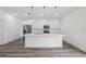 Modern kitchen featuring white cabinetry, stainless steel appliances, and a large kitchen island at 6062 Sw 154Th Pl, Ocala, FL 34473