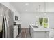 Modern kitchen featuring white cabinetry, stainless steel appliances, and a large island with a sink at 6062 Sw 154Th Pl, Ocala, FL 34473