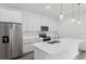 Bright kitchen with white cabinets, quartz counters, stainless steel appliances and center island at 6062 Sw 154Th Pl, Ocala, FL 34473