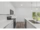 Modern kitchen featuring white cabinetry, stainless steel appliances, and a large island with a sink at 6062 Sw 154Th Pl, Ocala, FL 34473