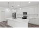 The kitchen features a center island, stainless appliances, and modern lighting at 6062 Sw 154Th Pl, Ocala, FL 34473