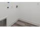 A laundry room features connections for appliances and grey vinyl flooring at 6062 Sw 154Th Pl, Ocala, FL 34473