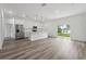 Bright living area featuring laminate flooring, kitchen and sliding glass doors at 6062 Sw 154Th Pl, Ocala, FL 34473