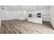 Spacious open-concept living area with kitchen, and durable laminate flooring at 6062 Sw 154Th Pl, Ocala, FL 34473