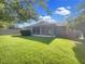 Expansive backyard featuring lush green grass, a screened patio, and privacy fencing, perfect for outdoor enjoyment at 704 Pickfair Ter, Lake Mary, FL 32746