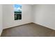 Clean, vacant bedroom with neutral walls, natural light, and carpeted floor, ready for personalization at 704 Pickfair Ter, Lake Mary, FL 32746
