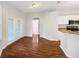 Dining area with wood-look flooring, white trim, and a view to the kitchen at 704 Pickfair Ter, Lake Mary, FL 32746