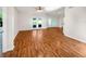 Spacious living area with gleaming hardwood floors and natural light, ideal for relaxing and entertaining guests at 704 Pickfair Ter, Lake Mary, FL 32746