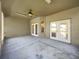 Covered patio with ceiling fan and double doors leading to the backyard at 704 Pickfair Ter, Lake Mary, FL 32746