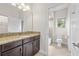 Bathroom with dark wood cabinets and granite countertops, next to tub/shower at 808 Sherbourne Cir, Lake Mary, FL 32746
