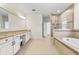 Bathroom with double vanity, granite countertop, tile flooring, standalone tub and glass shower at 808 Sherbourne Cir, Lake Mary, FL 32746