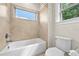 Bathroom features a white tub and toilet and a tiled shower at 808 Sherbourne Cir, Lake Mary, FL 32746