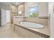 Elegant bathroom featuring a standalone tub, glass-enclosed shower, and decorative tile accents at 808 Sherbourne Cir, Lake Mary, FL 32746