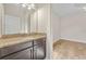 Bathroom with dark wood cabinets and granite countertops next to bedroom at 808 Sherbourne Cir, Lake Mary, FL 32746