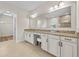 Bathroom with double vanity, granite countertop, tile flooring, and large mirror at 808 Sherbourne Cir, Lake Mary, FL 32746