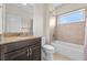 Bathroom with granite countertop, dark wood cabinets, tile flooring, bathtub, and shower combination at 808 Sherbourne Cir, Lake Mary, FL 32746