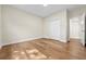 Bedroom featuring hardwood floors, a closet, and a doorway leading to another room at 808 Sherbourne Cir, Lake Mary, FL 32746