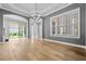 Open dining room space with wood flooring, large windows, and modern light fixtures at 808 Sherbourne Cir, Lake Mary, FL 32746