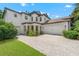Elegant two-story home featuring a stone-accented entrance, three-car garage and meticulously paved driveway at 808 Sherbourne Cir, Lake Mary, FL 32746