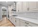 Kitchen featuring white cabinetry, modern stainless range hood, and matching countertops at 808 Sherbourne Cir, Lake Mary, FL 32746