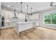 Bright kitchen with stainless appliances, subway tile backsplash, custom hood, island and wood floors at 808 Sherbourne Cir, Lake Mary, FL 32746