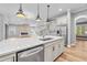 Open kitchen with island, quartz countertops, stainless steel appliances, with a view of the fireplace at 808 Sherbourne Cir, Lake Mary, FL 32746