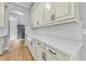 Kitchen with white cabinetry, white countertops and stainless hardware and fixtures at 808 Sherbourne Cir, Lake Mary, FL 32746
