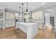 Open kitchen featuring a large center island, stainless appliances, and modern lighting at 808 Sherbourne Cir, Lake Mary, FL 32746