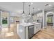 Modern kitchen with island, stainless appliances, and open layout flowing into a living area with fireplace at 808 Sherbourne Cir, Lake Mary, FL 32746