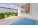 Covered patio features neutral tile floor and views of the home's manicured landscaping at 808 Sherbourne Cir, Lake Mary, FL 32746