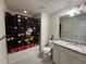 Charming bathroom showcasing a vanity with granite counters and a Mickey Mouse shower curtain at 8926 Zurich Ln, Kissimmee, FL 34747