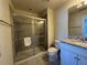 Elegant bathroom with a glass-enclosed shower and a vanity with granite countertop at 8926 Zurich Ln, Kissimmee, FL 34747