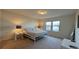 Bright bedroom with a queen size bed, bright furnishings, and a window at 8926 Zurich Ln, Kissimmee, FL 34747