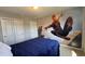 Bedroom with a blue comforter bed and a large Spiderman mural at 8926 Zurich Ln, Kissimmee, FL 34747