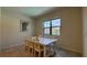 Bright dining area featuring a white table with seating for six, and natural light from a window overlooking the community at 8926 Zurich Ln, Kissimmee, FL 34747