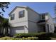 Two-story home boasts a two-car garage, well-maintained landscaping, and traditional architectural details at 8926 Zurich Ln, Kissimmee, FL 34747