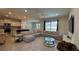 Open-concept living area with tile floors, a sectional sofa, and island with pendant lighting at 8926 Zurich Ln, Kissimmee, FL 34747
