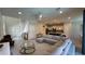 Open-concept living and kitchen area with tiled flooring, modern furniture, and pendant lights at 8926 Zurich Ln, Kissimmee, FL 34747