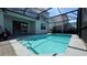 Inviting swimming pool with clear blue water and a screened enclosure at 8926 Zurich Ln, Kissimmee, FL 34747