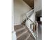 Carpeted staircase with white railing, leading to the upper level of the home with neutral color scheme at 8926 Zurich Ln, Kissimmee, FL 34747
