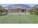 Large backyard with lush lawn, pool, and screened patio at 927 Orange Cosmos Blvd, Davenport, FL 33837