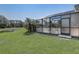 Spacious backyard featuring a screened-in pool area and view of the pond at 927 Orange Cosmos Blvd, Davenport, FL 33837