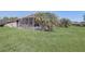 Expansive backyard featuring a screened-in patio and mature landscaping providing a private outdoor oasis at 927 Orange Cosmos Blvd, Davenport, FL 33837