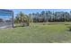 Large backyard with lawn and pond views next to screened-in pool at 927 Orange Cosmos Blvd, Davenport, FL 33837