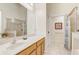 Bathroom featuring a large mirror, spacious vanity, and walk-in shower with glass doors at 927 Orange Cosmos Blvd, Davenport, FL 33837