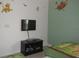 Bedroom features twin bed, Lion King themed decals, and a flat screen television at 927 Orange Cosmos Blvd, Davenport, FL 33837