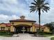 Stunning clubhouse featuring a clock tower, grand fountain, and mature landscaping at 927 Orange Cosmos Blvd, Davenport, FL 33837