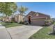 Well-maintained home features a lush lawn, mature landscaping, and a two-car garage for curb appeal at 927 Orange Cosmos Blvd, Davenport, FL 33837