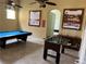 Spacious game room features a foosball table and a pool table perfect for Gathering fun at 927 Orange Cosmos Blvd, Davenport, FL 33837