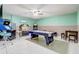 Spacious game room featuring a pool table, jukebox, arcade games, and air conditioning at 927 Orange Cosmos Blvd, Davenport, FL 33837